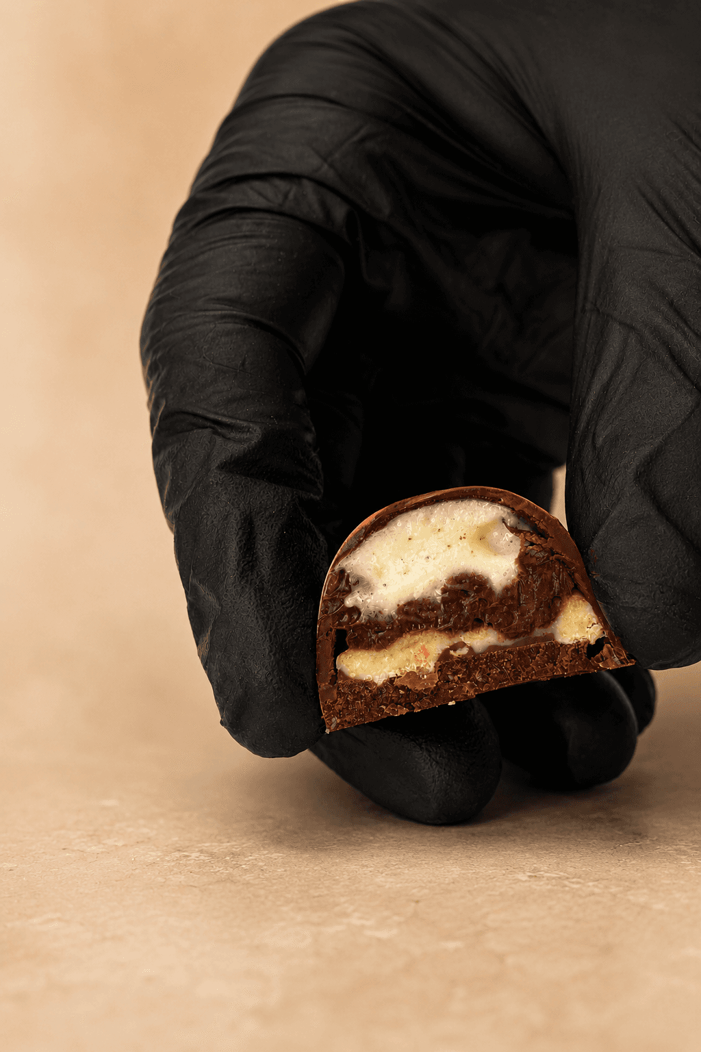 Bombom S'mores da Saito Chocolatier — corte revelando marshmallow e crocante